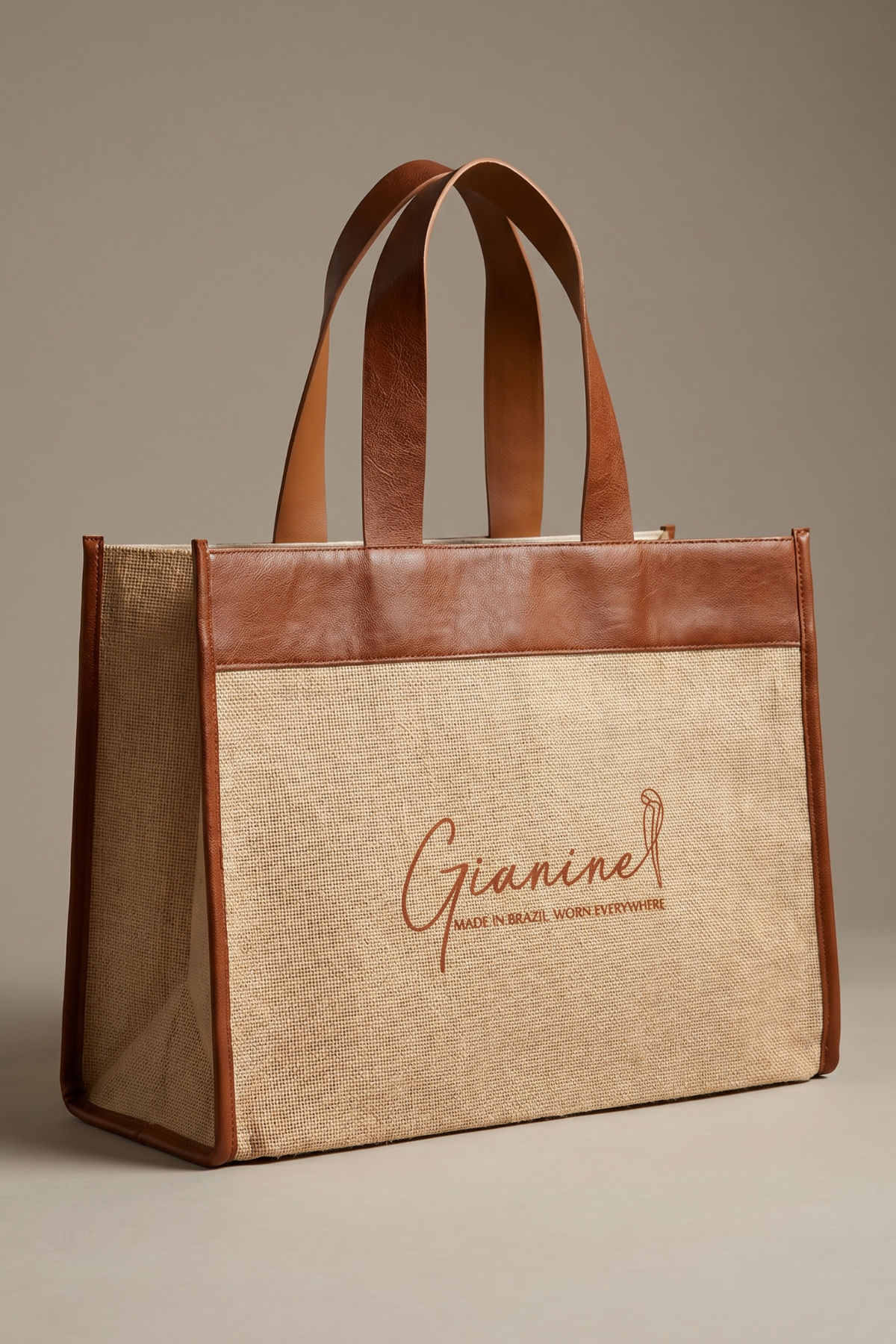 Natural canvas beach tote with premium brown leather accents and structured silhouette. The Gianine tote combines timeless style with practical storage for resort vacations, poolside essentials, and daily carry.